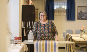Kristiina stryker en bordduk i husbolagets allmänna utrymmen.
