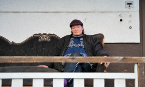 Seppo Renvall sitter i soffan och tittar in i kameran.